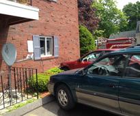 Driver crashes into her apartment building