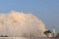 Building imploded near Statue of Liberty; dust cloud visible in several boroughs and New Jersey