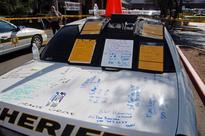 Photos from Tucson shooting show patrol car as makeshift whiteboard, high-capacity magazines