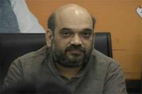 BJP wilts, promotes 'murder tainted' Amit Shah as Narendra Modi flex...