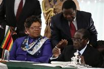 Mugabe signs Zimbabwe constitution, paving way for vote