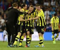 Dortmund hold on despite late Real rally