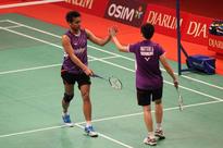 Doing the Danes: Tontowi Ahmad (left) high-fives his partner Liliyana Natsir in their match against Mads Pieler Kolding and Kamilla Rytter Juhl of Denmark on Tuesday. The Indonesian pair advanced to second round. (JP/Wendra Ajistyatama)
