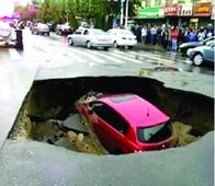 Chinese family car swallowed up by giant sinkhole