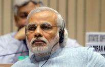 Modi's dual message: Face of development for country and hard-core Hindutva for UP