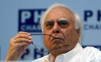 AAP blames Kapil Sibal, son in Vodafone tax case