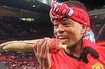 Evra mocks Suarez by chewing on fake arm